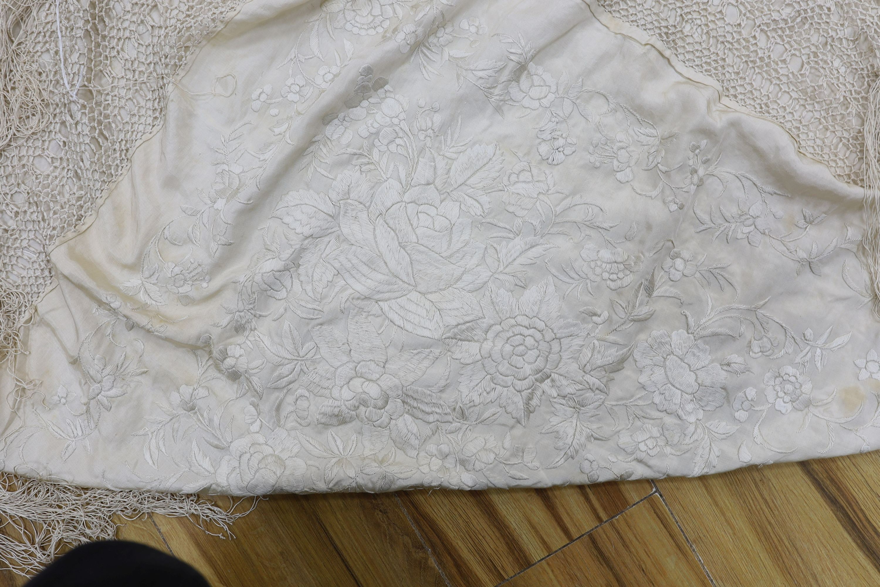 A 19th century cream embroidery on cream silk shawl together with a smaller later shawl